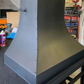 Flue baffle control on the side of steel studded inglenook canopy
